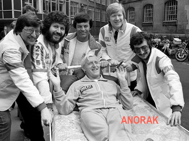 Radio One Disc Jockeys take time off to push Jimmy Savile from Broadcasting House to Park Lane by bed, in aid of the Variety Club of Great Britain and the Outward Bound Trust. (L-R) Simon Bates, Dave Lee Travis, Tony Blackburn, Kid Jensen and Steve Wright.