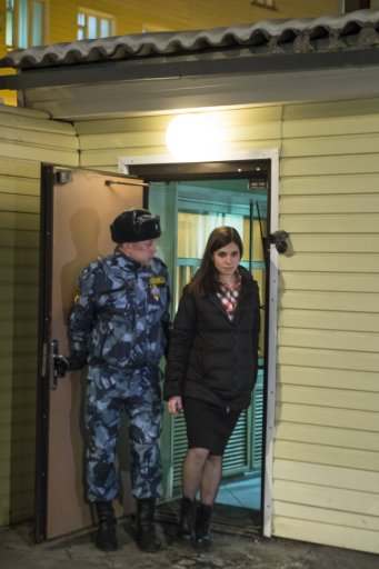 Nadezhda Tolokonnikova, right, leaves prison in Krasnoyarsk, Russia, Monday, Dec. 23, 2013. The third member of the Russian punk bank Pussy Riot has been released from custody following an amnesty law passed by parliament. Tolokonnikova left the prison colony in the eastern Siberian city Krasnoyarsk on Monday, hours after another band member, Maria Alekhina, was released in another region. (AP Photo/Tatyana Vishnevskaya)