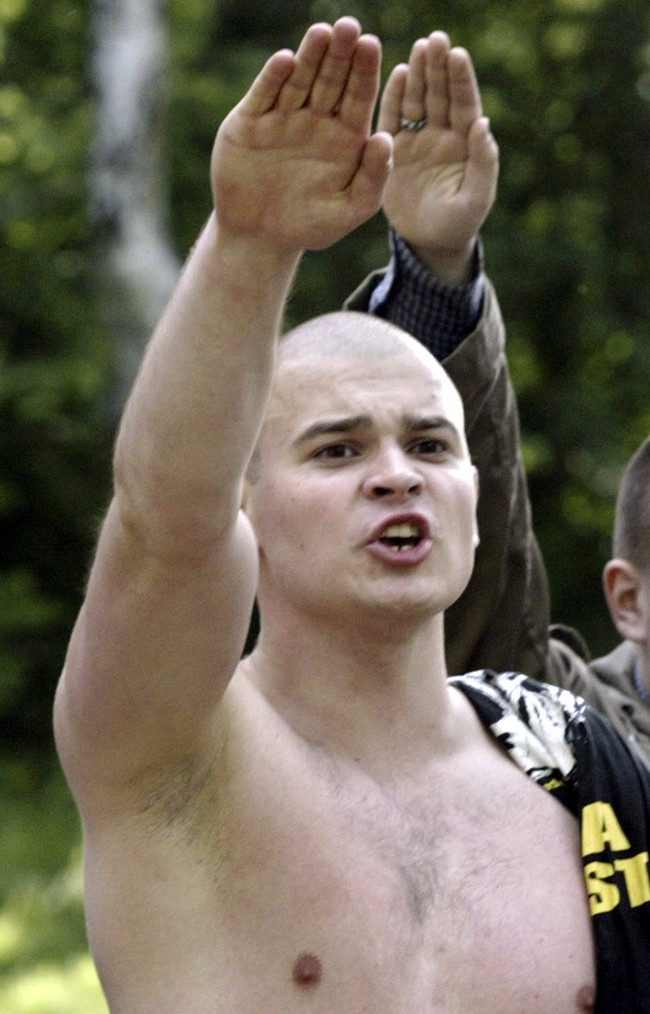 Maxim Martsinkevich, also known as "The Hatchet" in Russian, gives the Nazi salute during a gathering of skinheads outside Moscow, in this June 16, 2004, file photo. A Moscow court sanctioned the arrest of Martsinkevich for his role as a leader in a right-wing ultrtanationalist group, the RIA-Novosti news agency reported on Wednesday, July 4, 2007. Russia has seen a spike in racist and anti-immigrant violence in recent years. 