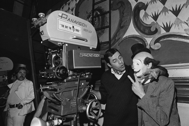 Jerry Lewis, center, shot first sequence of his film The Day the Clown cried and seen here left with French actor Pierre Etaiy, right, March 20, 1972, Paris, France.