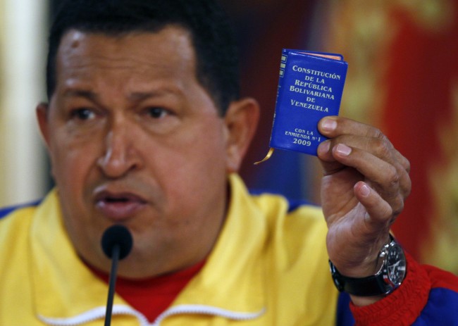 Venezuela's President Hugo Chavez holds up a small copy of the constitution at a press conference with foreign media at Miraflores presidential palace in Caracas, Venezuela, Monday, Sept. 27, 2010. Opponents of Chavez made gains in congressional elections Sunday that weaken the president ahead of his next re-election bid and could force him to deal with rivals. (AP Photo/Fernando Llano)